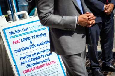 eric adams with sign for mobile covid testing